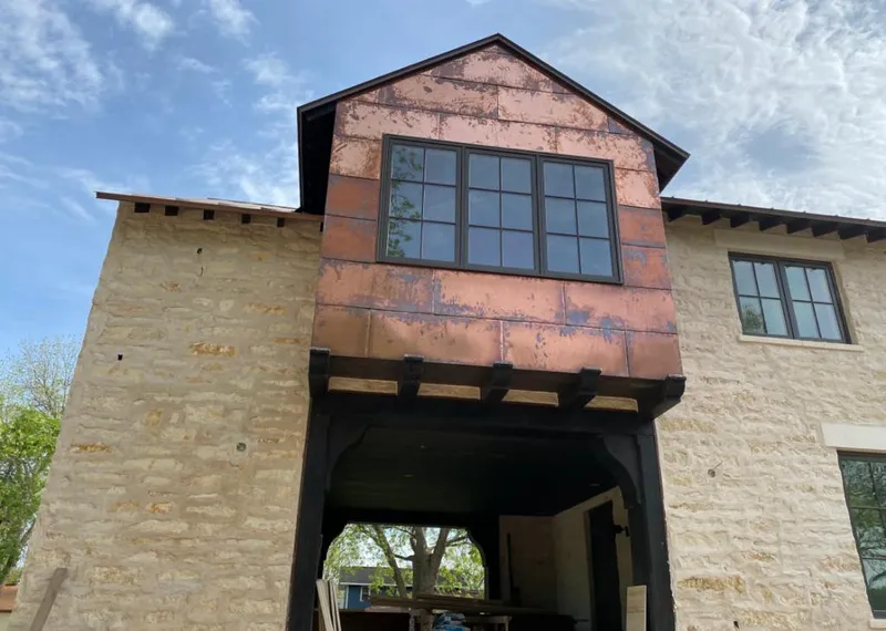 Copper metal panel facade on a stone building for Skylight Installation in Spring Lake
