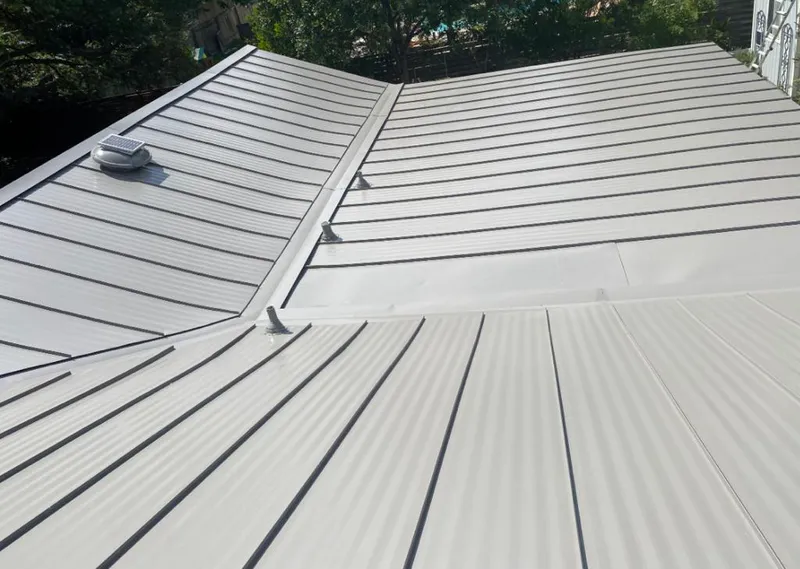Solar attic fan installed on a metal roof for Roof Ventilation in Spring Lake
